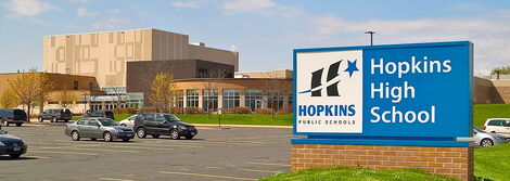 A signpost showing Hopkins High School