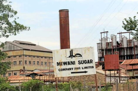 A signpost showing Miwani Sugar Company entrance