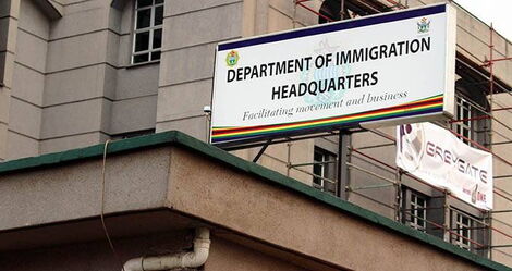 A signpost showing the Department of Immigration Headquarters in Zimbabwe