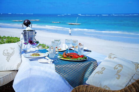 A table set for holidaymakers next to the Indian Ocean in Kenya