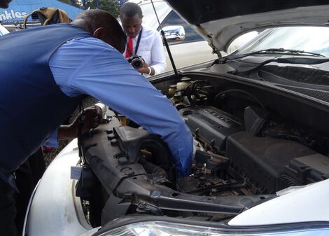 A technician working on a car.