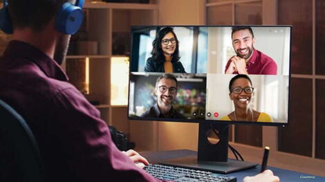 A user watches a video conference in a promotional image from Gumzo.
