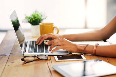 A woman using a laptop to study