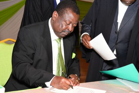 ANC leader Musalia Mudavadi signs an entrance book after arriving at the Bomas of Kenya.