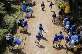 An aerial view of pupils at a school sanitizing at various stations set up as per the Ministry Of Health regulations.