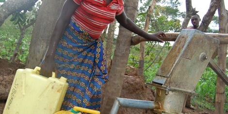 An image of a woman fetching water at a borehole.jpg