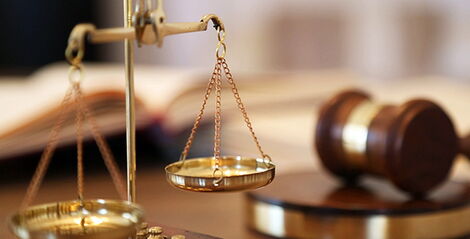 An image of a legal scale and a gavel.