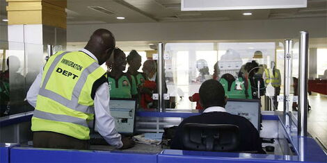 A photo of an immigration official serves travellers at the Jomo Kenyatta International Airport (JKIA) in Nairobi.
