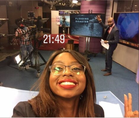Anita Nkonge takes a selfie at NTV studio with News anchor Mark Masai in the background.