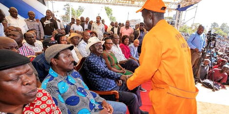 Azimio Chief Raila Odinga interacts with a Kenyan at the Kamukunji Grounds for a consultative forum on Wednesday, December 7, 2022