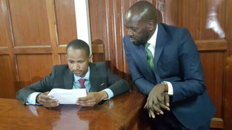 Embakasi East MP Babu Owino peruses court documents in the company of his lawyer Cliff Ombeta at the Millimani Law Courts on January 27, 2020.