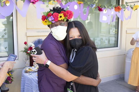 Bancy Gatimu on her last day at work hugging nurse Jessica Dizon-Rosales whom she mentored