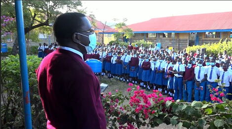 A photo of Wilson Achoko, the Principal of Barwessa Secondary School together with other students at the assembly grounds on Tuesday, November 16, 2021.