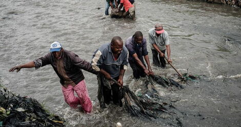 Divers retrieving bodies from a river (undated)