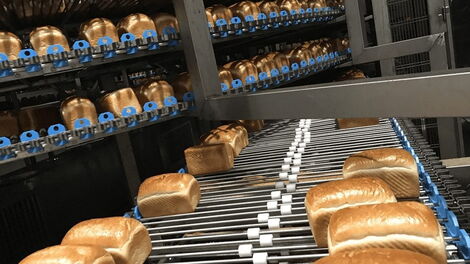 Loaves of bread being baked at a bakery