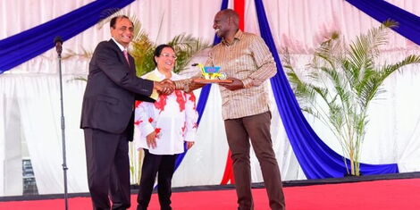 Businessman Narendra Raval (left) gifting President William Ruto (right) in 2022