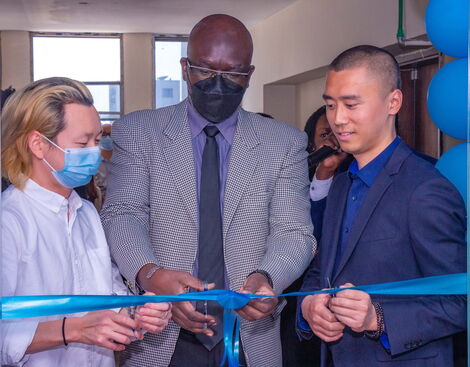 CEO and Co-founder Shiva, Co-Director Zheng and a guest, Isaac cutting ribbon to officially open the ceremony