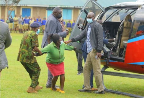 CS Matiang'i Looks On as Police Officers Pull Away Woman Who Breached his Security.