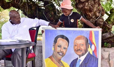 Sidney Sheldone presents Ugandan President Yoweri Museveni with a portrait of himself in Rwakitura in 2019. 