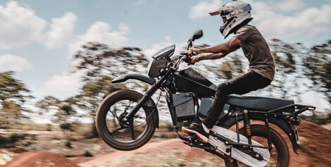 A person riding an electric motorcycle launched by Opibus company.