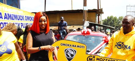 Social Media Influencer Amber Ray awards carpenter Simon Airo with his Omoka na Moti Promotion prize, a brand new Proton Saga.