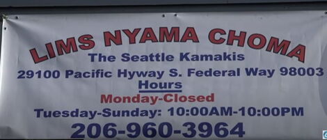 A signpost of Lims Nyama Choma located in Seattle, US along pacific highway.