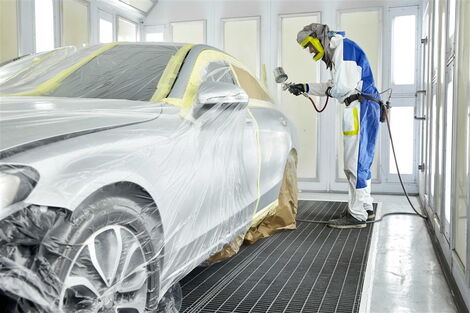 A car at a mechanic shop being repainted