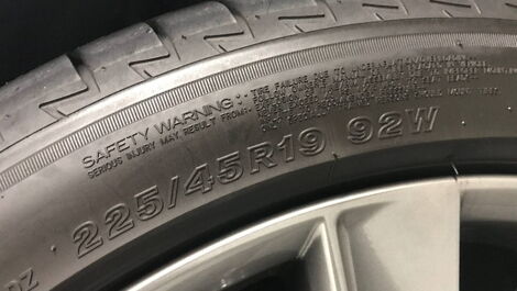 A car tyre with different letters and numbers inscribed on top
