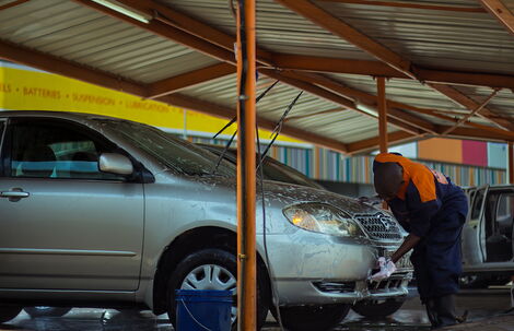 File photo of different car models at a car wash being cleaned