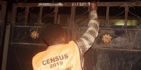A photo of a Census 2019 enumerator branding an enumerated residence in the August 2019 exercise.