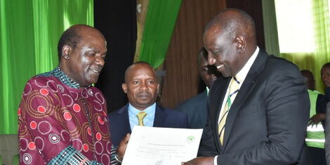 Deputy President William Ruto (right) receives the certificate of nomination to vie for the presidency from IEBC Chairperson Wafula Chebukati at the Bomas of Kenya on Saturday, June 4, 2022
