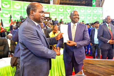 IEBC Chairman Wafula Chebukati handing over an election certificate to President-elect William Ruto at Bomas of Kenya on August 15, 2022