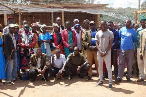 Chris Saidimu, a teacher at Somutwo Primary School in Laikipia West, Laikipia County rares chicken to help students with members of the community who visited his project