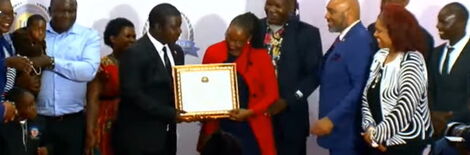 Citizen TV Reporter Chrispine Otieno receiving an award on Saturday February 26, 2022