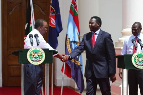 Former Energy CS Davis Chirchir shakes hand with President Uhuru Kenyatta after being appointed into office in April 2013