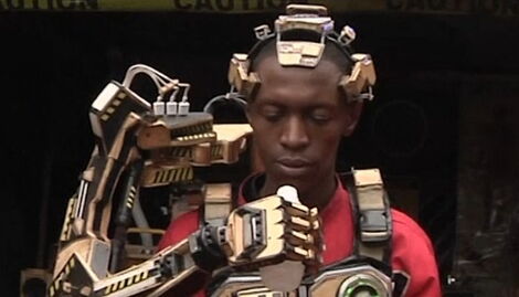 David Gathu demonstrates how the robotic arm works .