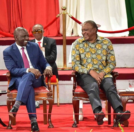Deputy President William Ruto (left) and President Uhuru Kenyatta enjoy a hearty moment during the BBI launch at the Bomas of Kenya on November 27, 2019.