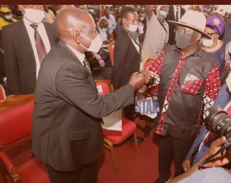 Deputy President William Ruto (left) greets former Prime Minister Raila Odinga at the Kisii funeral