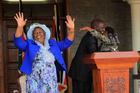 Deputy President William Ruto embraces his wife Rachel after addressing journalists at his Karen office as his mother, Sarah Cheruiyot waves at journalists. April 2016.