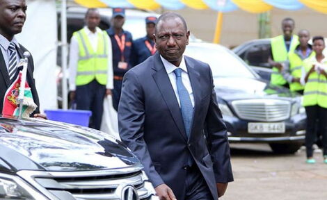 Deputy President William Ruto walking past his vehicle