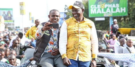 Deputy William Ruto and Kakamega Senator Cleophas Malala take a selfie atop a vehicle in Kakamega County on Sunday, July 31, 2022.