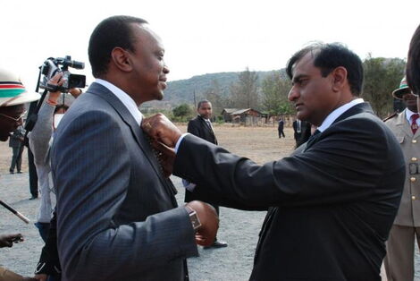 Devki Group of Companies founder Narendra Raval (right) fixes President Uhuru Kenyatta's tie