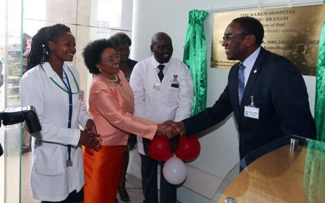 Karen Hospital chairman Dr James Mageria (right) with the hospital's CEO Dr Betty Gikonyo and staff members