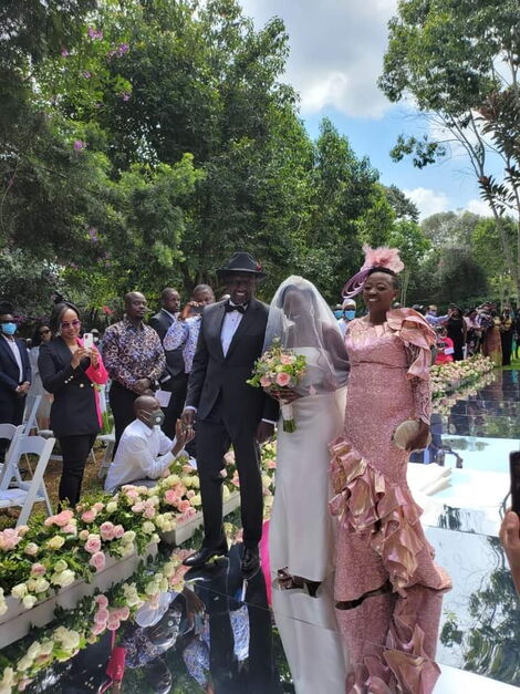 June Ruto walks down the aisle accompanied by her parents DP William Ruto and Rachel Ruto on Thursday, May 27.