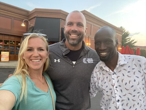 Wesley Korir (Right) poses for a photo with his wife and a friend on August 10, 2021.