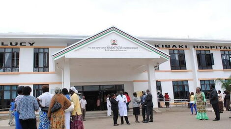 People stand outside the Mama Lucy Kibaki Hospital in Umoja II, Nairobi.