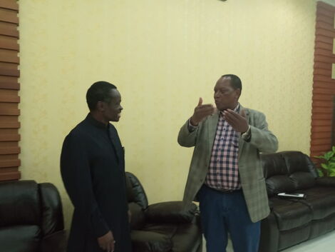 Tanzania Minister for Foreign Affairs Palamagamba Kabudi(Right) and PanAfricanist PLO Lumumba ahead of the mining conference in Dar es Salaam on February 22, 2020.
