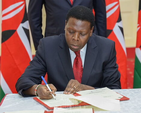 Devolution Cabinet Secretary Eugene Wamalwa signing the deed of transfer on Tuesday, February 25, at State House, Nairobi