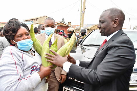 Deputy President William Ruto when he made a stop in Machakos buying Maize from Elizabeth Mueni