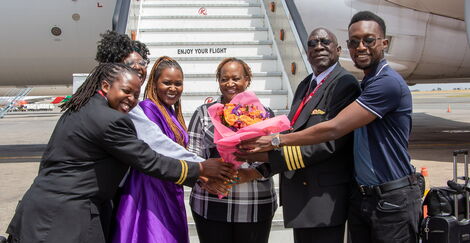 Captain Constant Oteri together with his family outside a Kenya Airways plane.